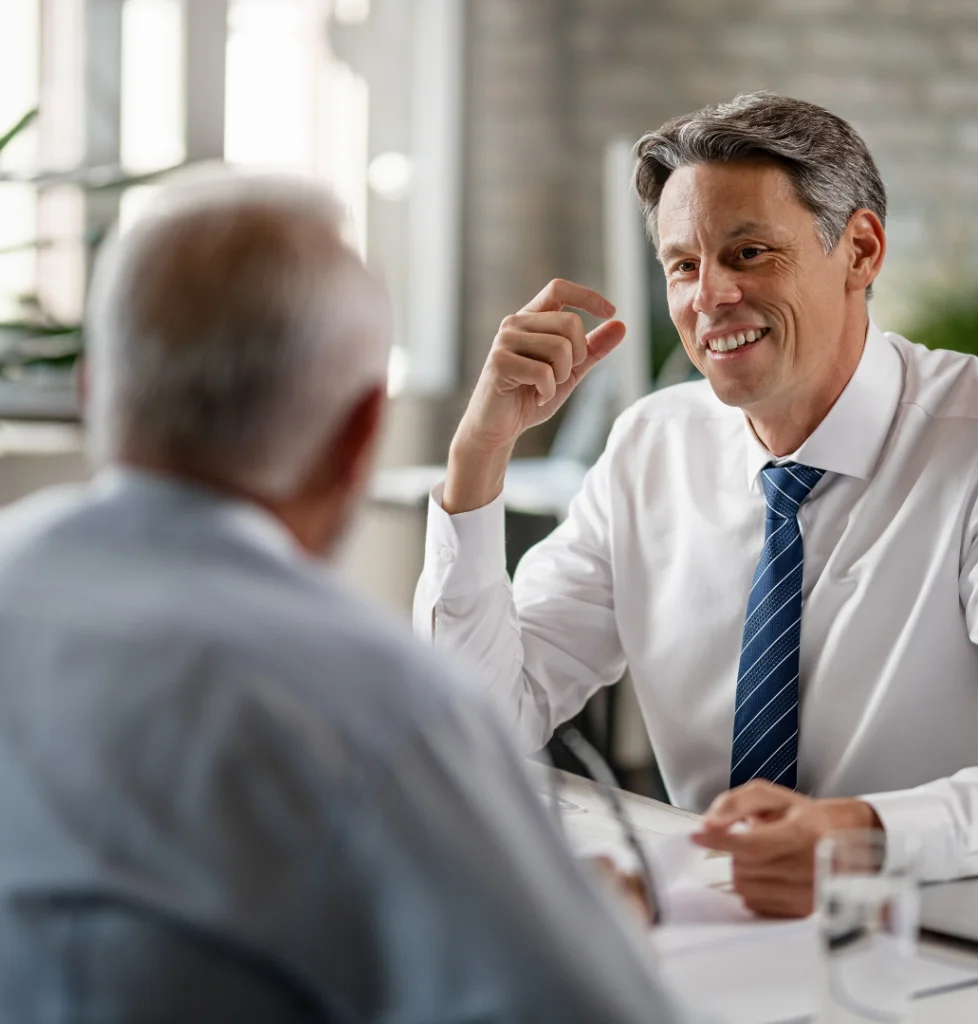 happy-insurance-agent-talking-with-mature-couple-about-their-retirement-plans-during-meeting-office